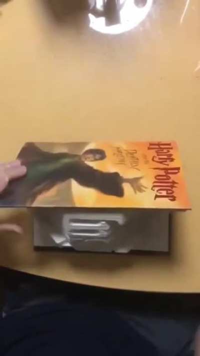 Folding book pages to spell "inspire"