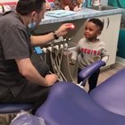 Dentist helps his nervous patient get comfortable before his checkup