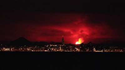 ? Reykjavik skyline illuminated by a volcano