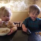 This sister feeding her brother his breakfast and asking him repeatedly, “Like it?”