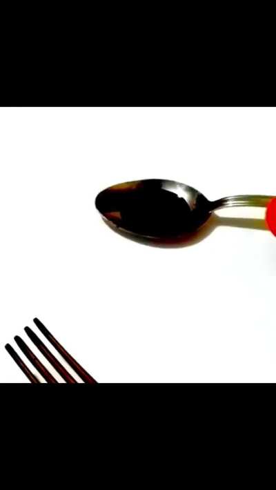 Artist uses forks and scissors to create calligraphy ?
