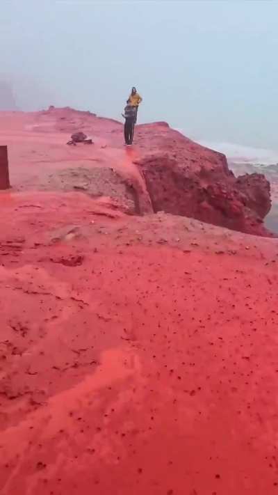? heavy rain at the red beach at Hormuz Island, Iran.