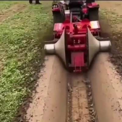 ? A construction machine that opens a smooth canal in the field.