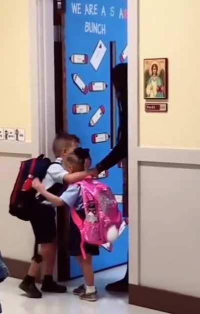 big brother comforting his nervous younger sister on their first day of class. I'm not crying you're crying ?