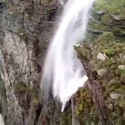 ? Waipuhia Falls, Oahu Island, Hawaii. Water is blown upward due to strong wind in waterfalls giving an apparent perception of water flowing upwards