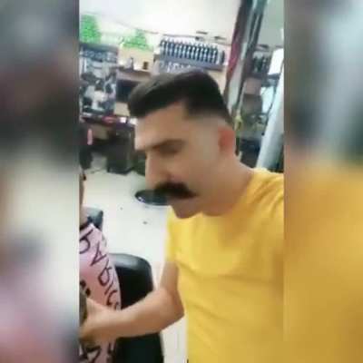 A Syrian Barber comforts a girl after cutting her hair cz she had some skin disease and she thought that she became ugly, " I'm ugly " she says, " no you are not ugly " he responds, and then he asked her to cut his hair off for him to show her that she do