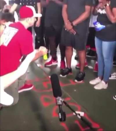 White people kneeling and "asking for forgiveness" to black people