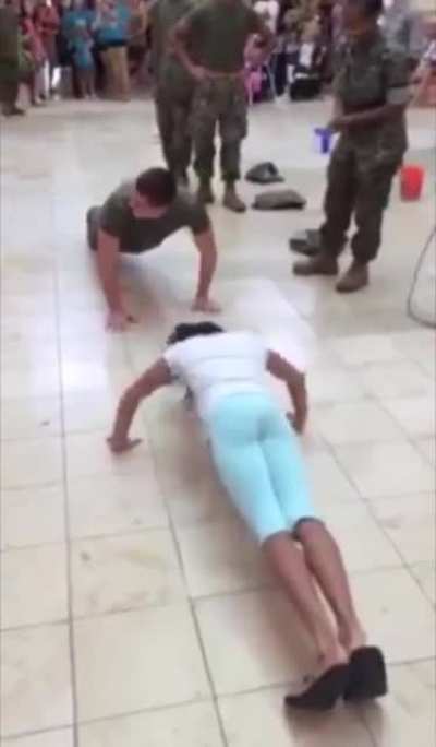 Girl does a push up challenge against a Marine.
