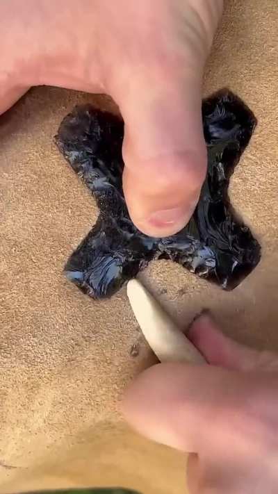 Fashioning ninja throwing stars from obsidian with the help of simple tools.