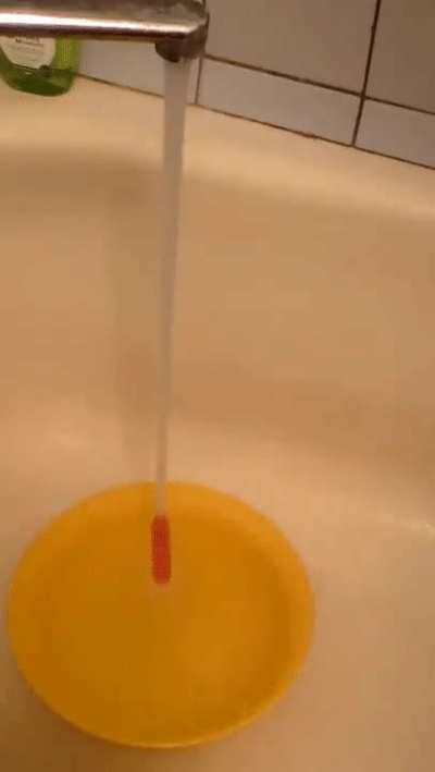 Straw ascends tap water stream