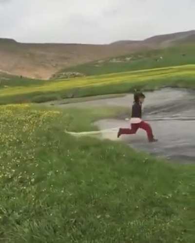 The kid trying to throw a net