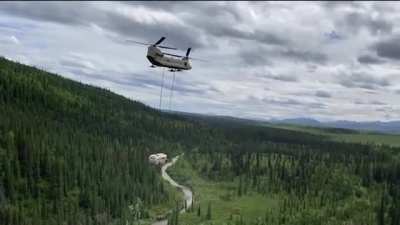 An Alaska Army National Guard CH-47 Chinook helicopter airlifting the "Magic Bus” out of the woods just north of Denali National Park and Preserve in Alaska