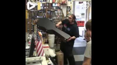 Dude is stoked over guitar; woman helps him pay