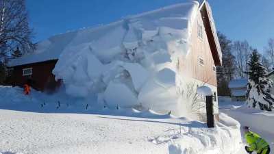 Using rope to remove snow from roof