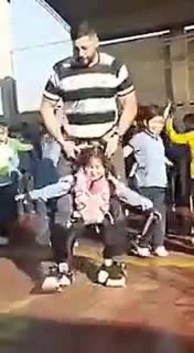Teacher makes dancing possible for tiny paraplegic student.