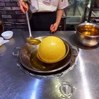 Frying a giant sesame seed ball