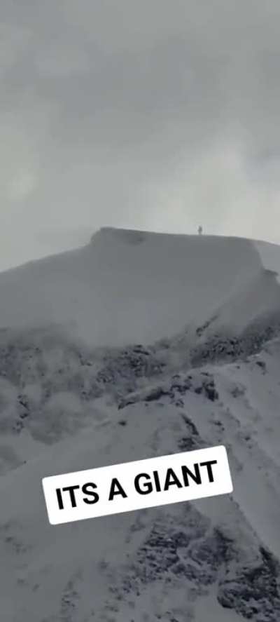 A giant walking on the top of the mountain