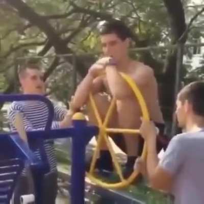 Going for a spin on the playground equipment in the wrong way