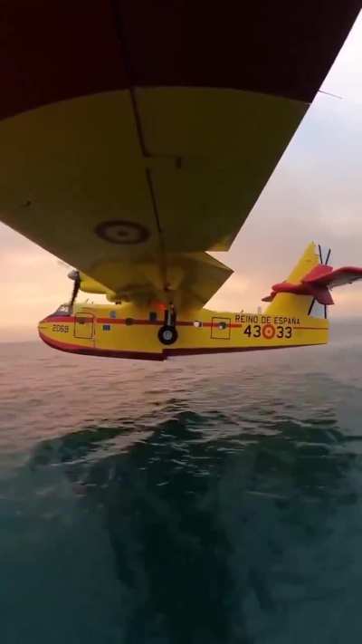 A firefighting plane loading water.