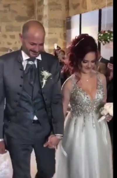 Dad walking with daughter down the isle.