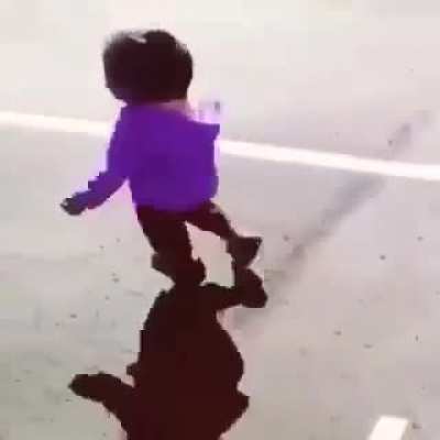 Little girl running away from her shadow