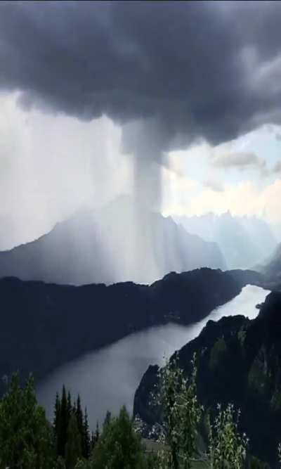 ? A massive down pour of rain moving over a moutian peak.