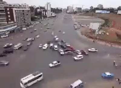 Behold the bustling streets of Ethiopia's busiest intersection, where a mesmerizing dance of vehicles and pedestrians unfolds without the conventional aid of traffic lights! ??‍♀️✨