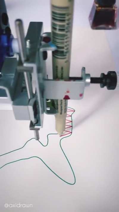 Pen plotter programmed to sync with piano piece "Clair de lune" (Debussy). Sound on is essential.