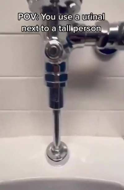Urinal with tall people next