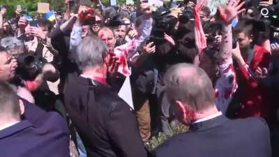 Russian ambassador doused with red paint by anti-war protesters as they chant "fascist, murderer"