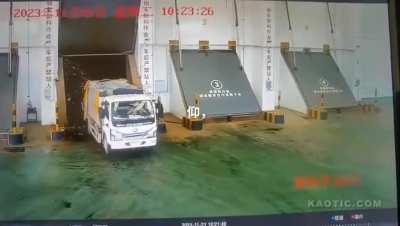 Garbage truck flips over during unloading