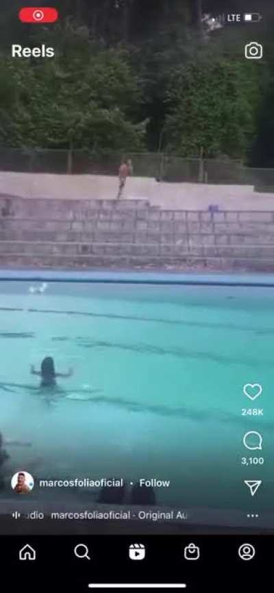Tries to jump into the pool, fails spectacularly
