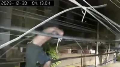 Cracked out man walks barefooted on telecommunication lines to cut cables.
