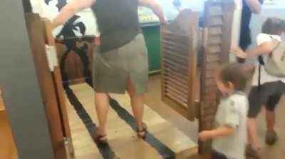 Standing behind a swinging door