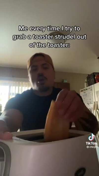 Grabbing a toaster strudel out of the toaster