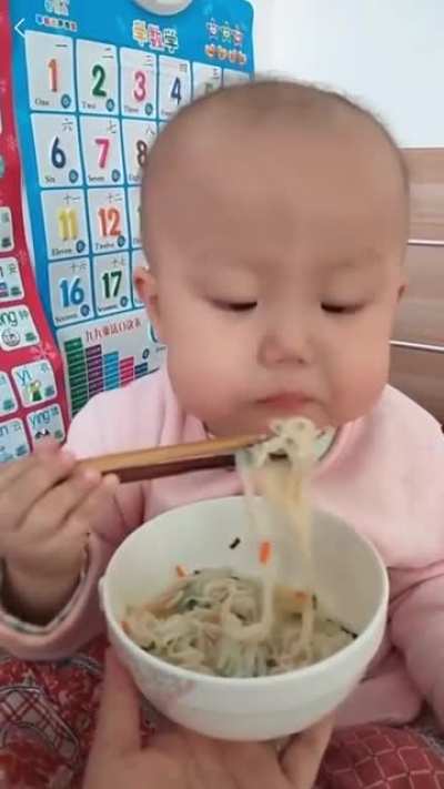 She uses the chopsticks better than you and me.