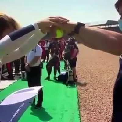 Formula one driver taking a reaction test before a race!