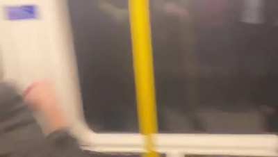 Football fan whose team just lost at home surrounded by rival football fans on the train