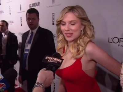 A woman completely disappearing behind Scarlett Johansson on the red carpet