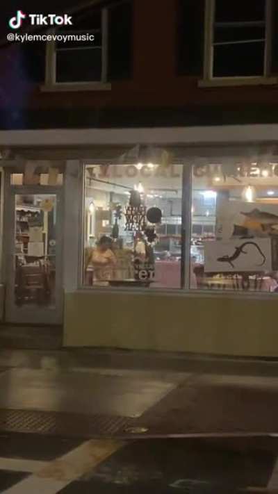 Sweet moment of a couple dancing in a closed shop