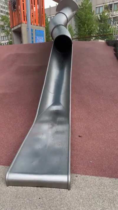 Policeman using a park slide...