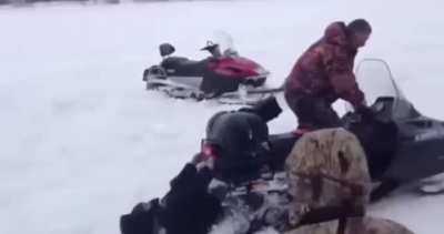 WCGW Standing behind Snow mobile