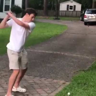 Playing golf in the yard.