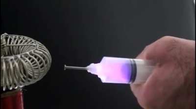 Extracting electricity from a tesla coil using a syringe is so cool.