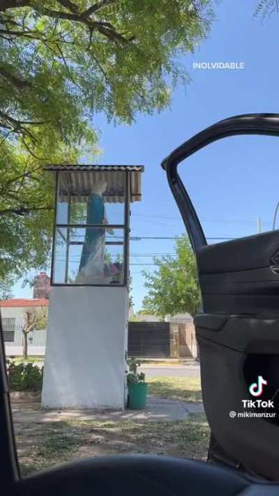 "I'll never forget about you, brother." Two Argentines listening to the defining penalty shot in the 2022 World Cup next to a statue of the Virgin Mary
