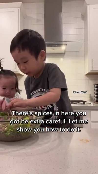 4 year old cooking with his baby sister ?