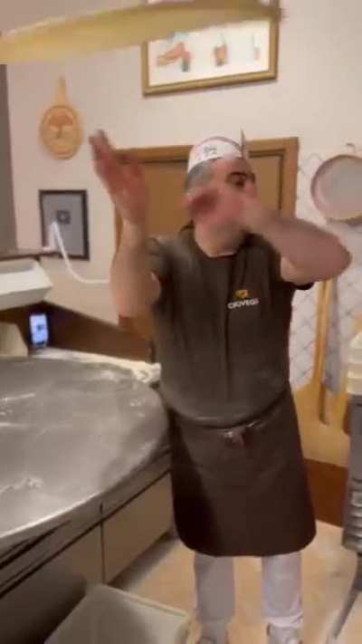 How he twirls the pizza dough, you can tell he's a master