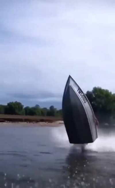Man performs motorcycle moves with a boat