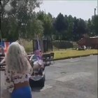Driving a scooter with two huge flags