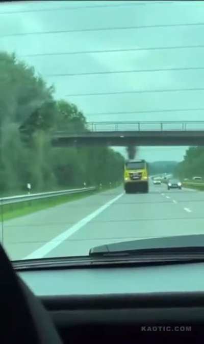 Tow truck fails to retract crane and nails a bridge on the freeway.